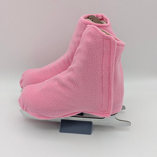 Pink fleece figure skate boot covers on a white background