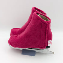 Deep pink figure skate boot covers on a white background
